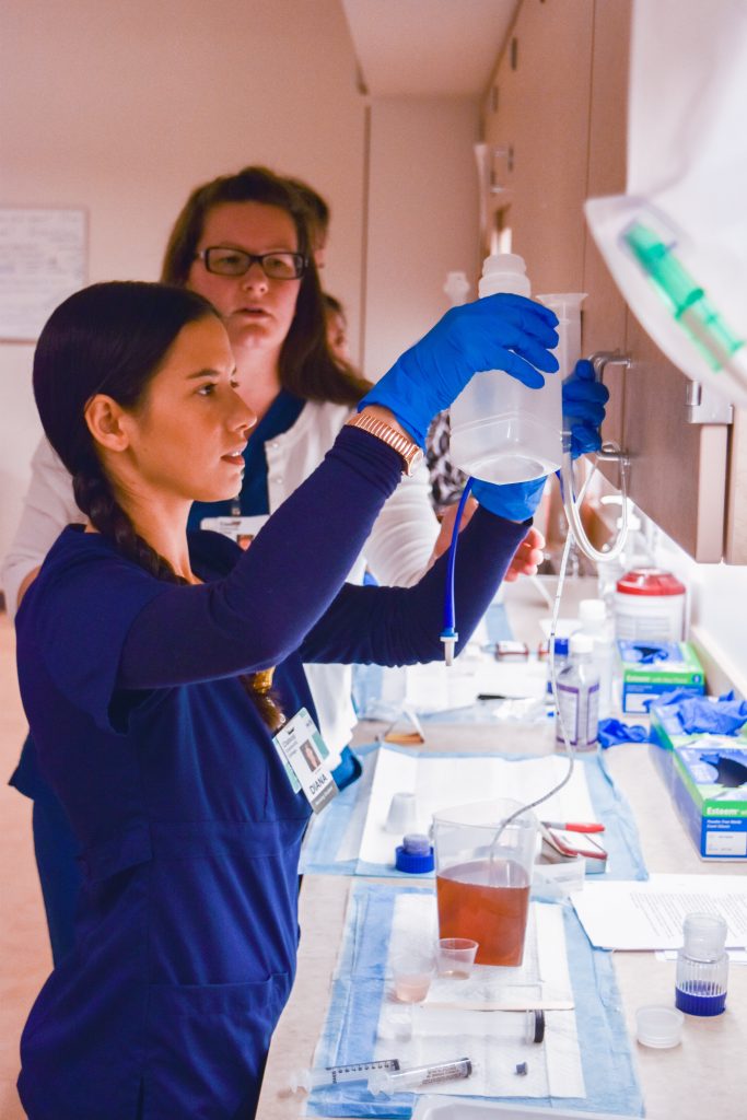 Nursing student does hands on learning during a lab