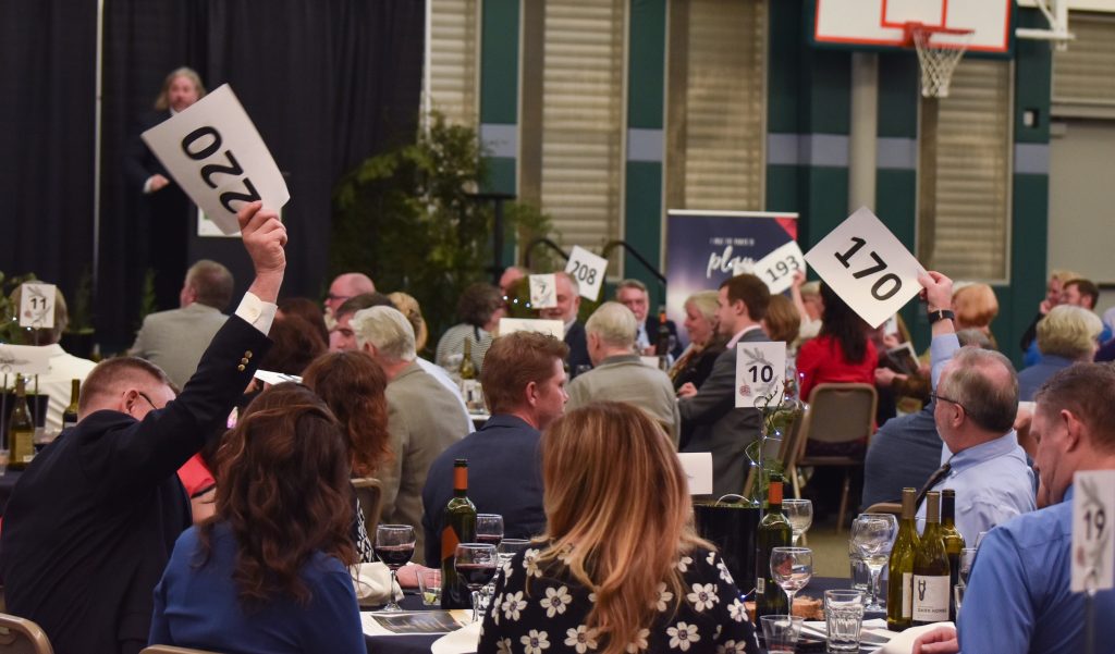 Auction attendees bid on items at the 2019 Foundation Auction and Dinner