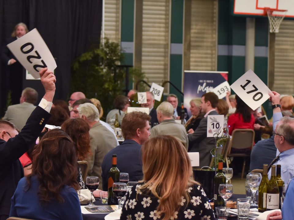 Auction attendees bid on items at the 2019 Foundation Auction and Dinner