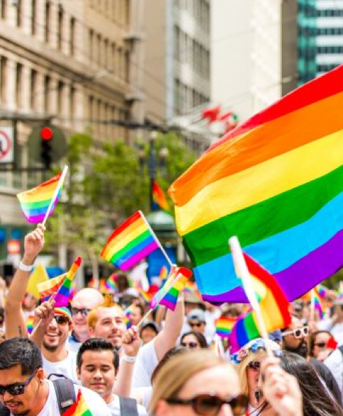 Pride parade with rainbow flags waving