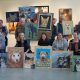 Students show off their paintings of local shelter cats and dogs that will be sold for a fundraiser for Clatsop Animal Assistance