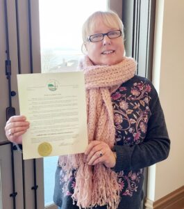 Kristen Wilkin shows off the City of Seaside Proclamation of CTE Month