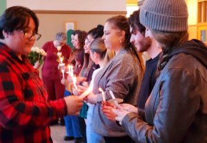 Students being inducted into the PTK honor society with the lighting of candles