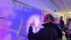 person drawing on wall at trantlerfest