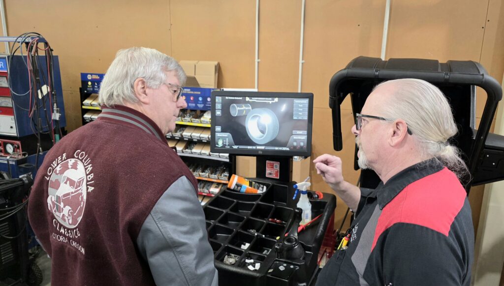 Automotive Instructor talks about new equipment to car club member