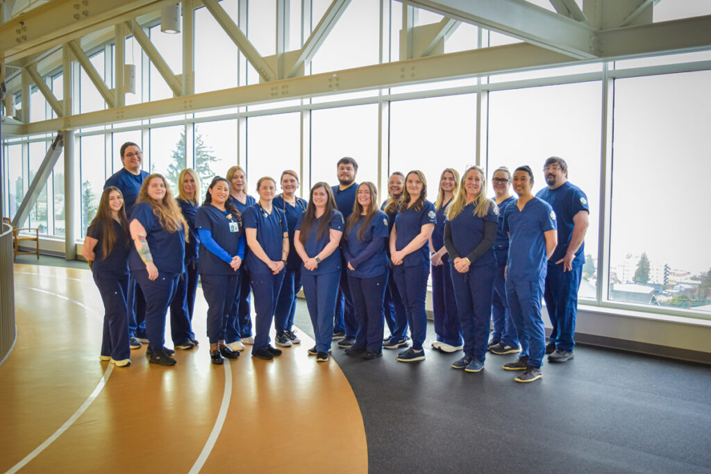 Class of 2026 Nursing Program Students standing in two rows dressed in scrubs