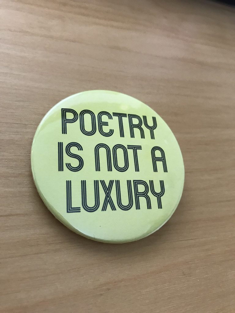 Button that says "Poetry is not a Luxury"