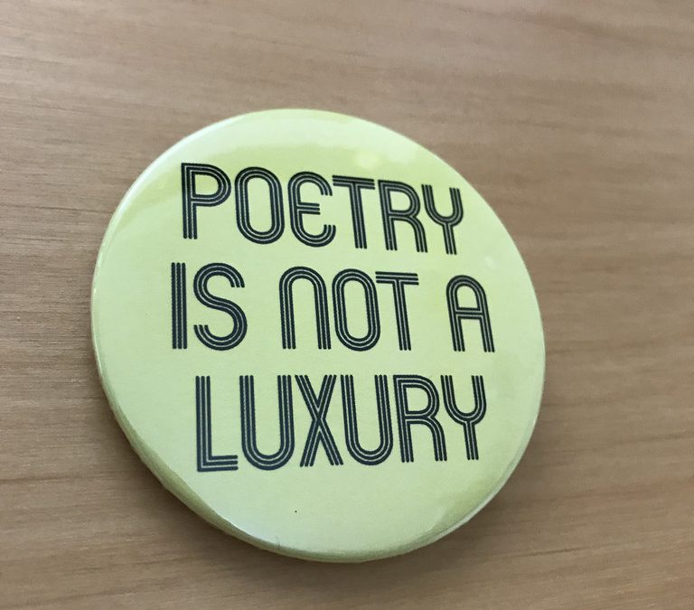 Button that says "Poetry is not a Luxury"