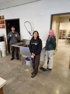 Tongue Point Job Corps students pose with the sink they just installed in the Art Building