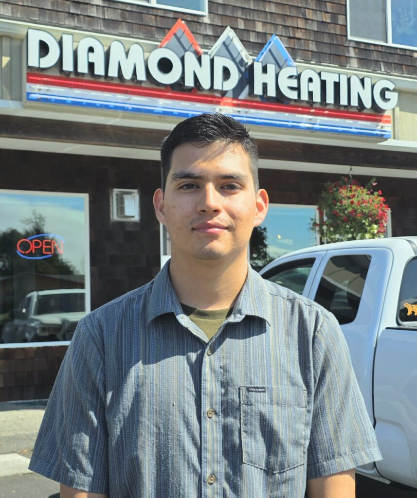 Alejandro Serna stands in front of Diamond Heating in Seaside, Oregon