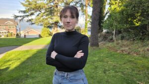 Brandi standing at Clatsop Community College with hands crossed in front of her