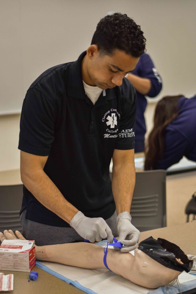 Student practices arm tourniquet technique