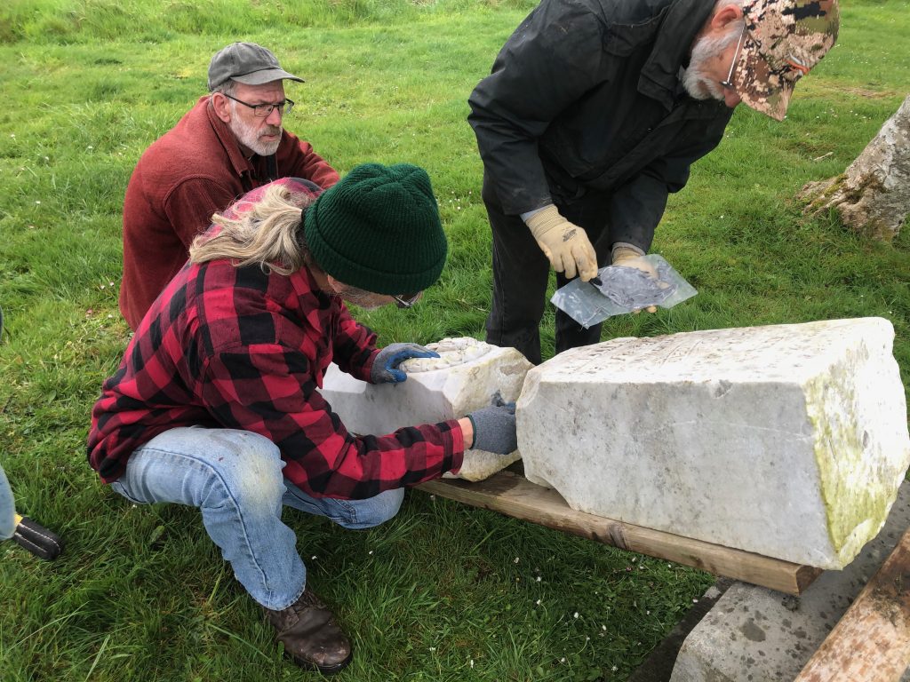 Lucien Swerdloff and class work on restoring a headstone