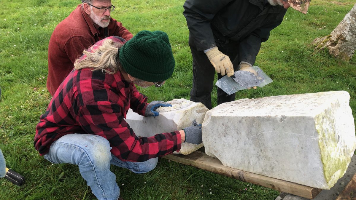 Lucien Swerdloff and class work on restoring a headstone
