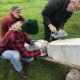 Lucien Swerdloff and class work on restoring a headstone