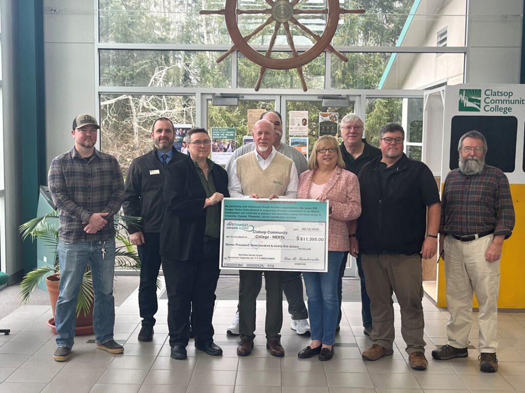Maritime faculty and administration gather to receive a check from Northwest Oregon Works for improvements to the Forerunner vessel