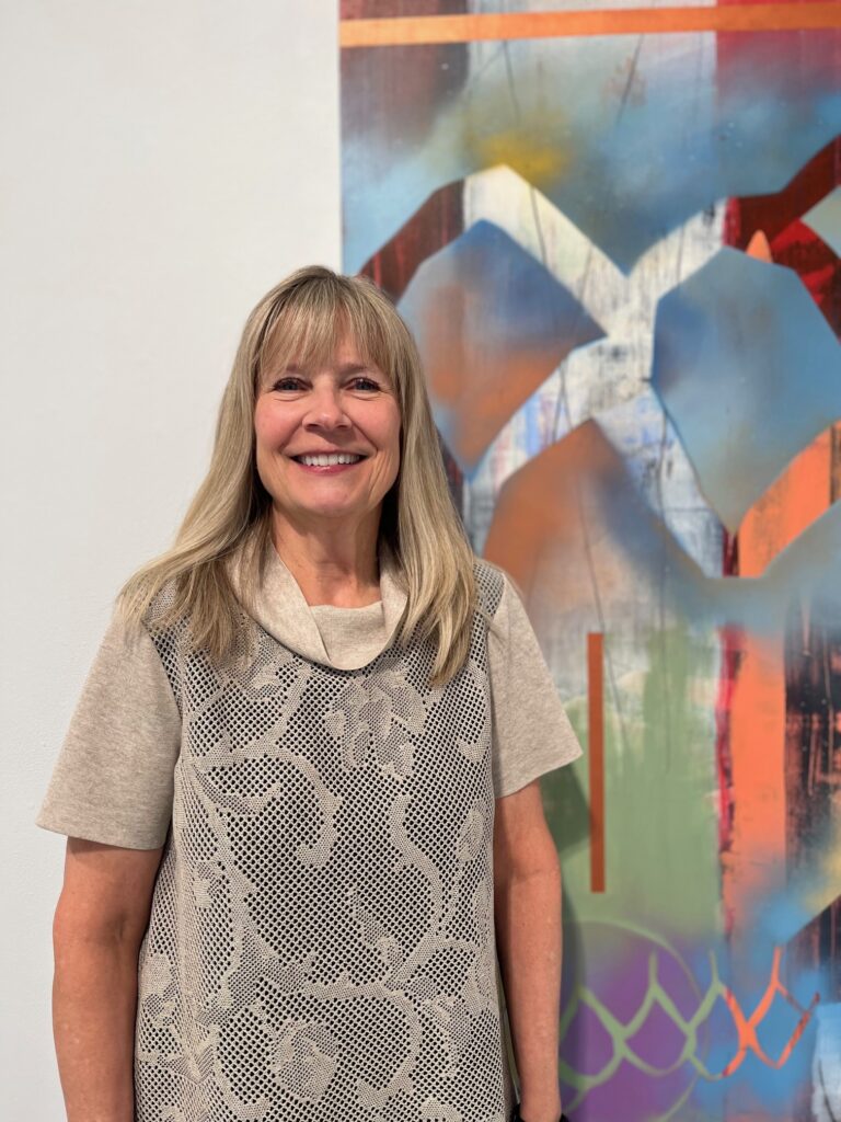 Martha Lee standing in front of a painting