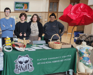 Students behind a table with art projects