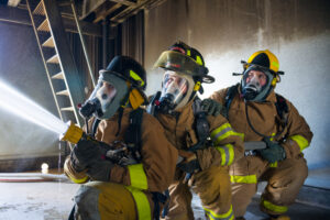 fire science students using air tank system while doing hands on training