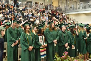 Graduates standing at the 2022 commencement ceremony
